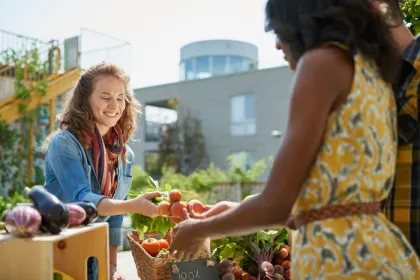 women buying and selling at a farmer's market
