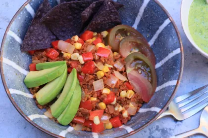 striped blue bowl with chopped vegies and avocado
