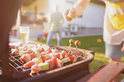 person grilling in evening sunlight