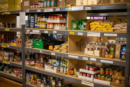 Food bank shelves containing dried and canned goods