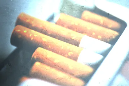 open pack of cigarettes with filter over it