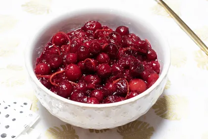 bowl filled with cranberries and sauce