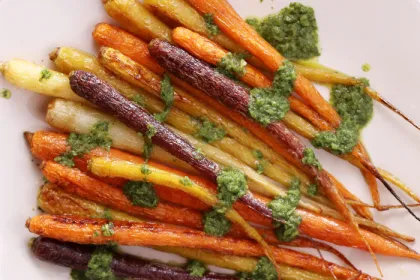 colorful roasted carrots covered in chimichurri sauce