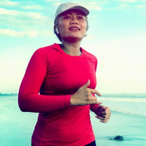 a woman jogging on the beach