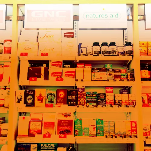 image of supplements on store shelves with an orange hue