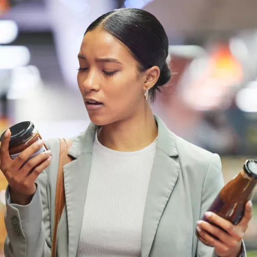 A woman reading food item packaging