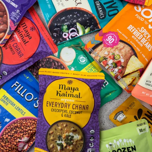 pile of pouches of pre-seasoned beans and lentils