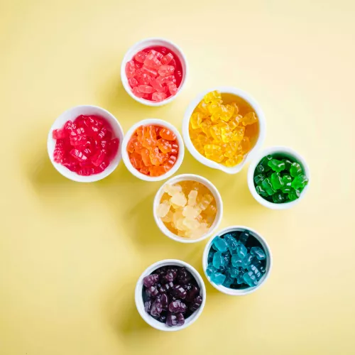 Different cups of brightly colored gummy candies