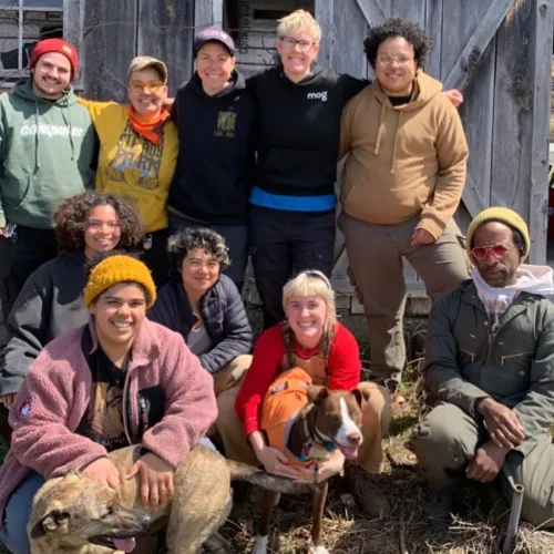 10 Farmers pictured in front of a barn at Rock Steady Farm.