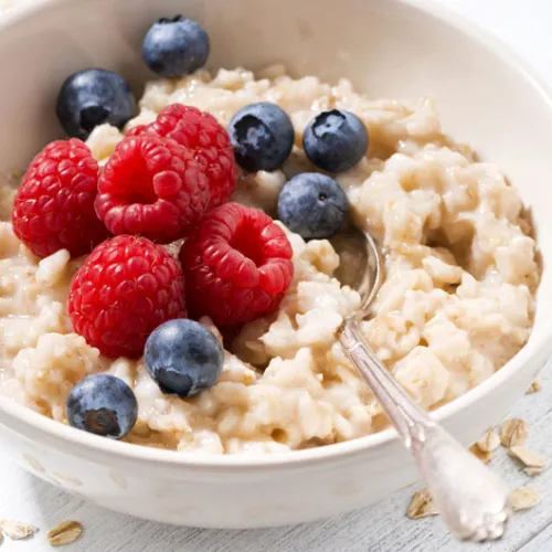 bowl of oatmeal with raspberries and blueberries