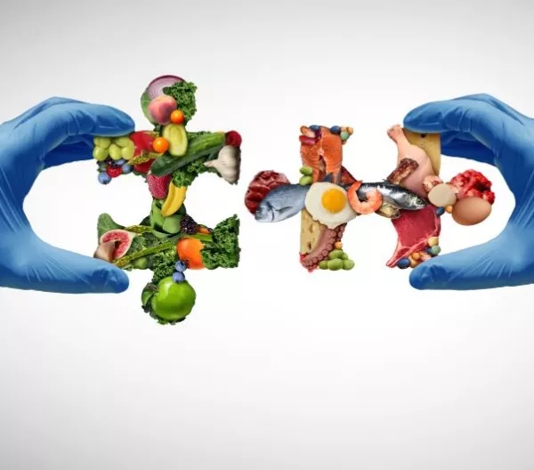 Nutrition science concept with food-group puzzle pieces held by hands in surgical gloves