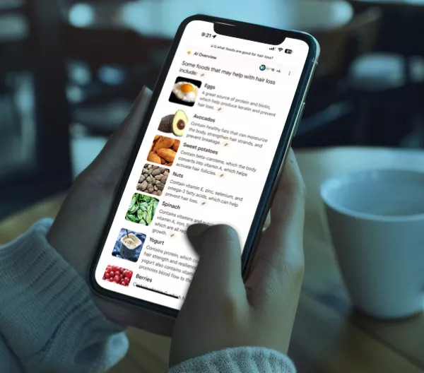 person scrolling on a smart phone in a coffee shop