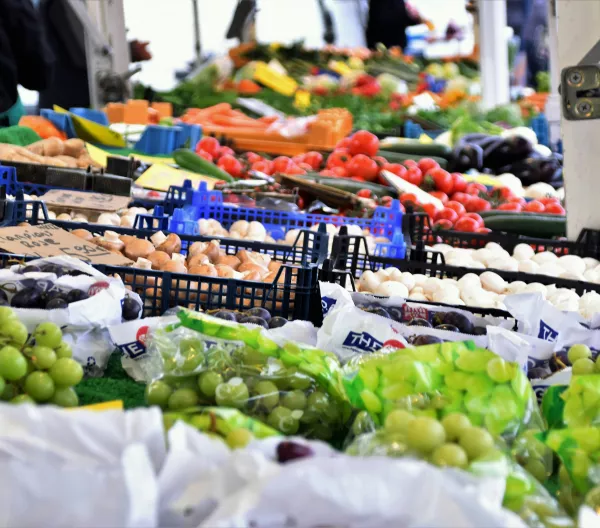 Green grapes and other produce on display at an outdoor market