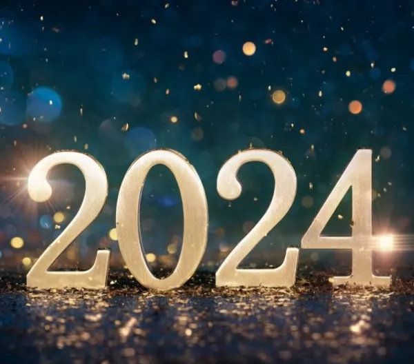 2024 in gold numerals on a reflective surface in front of deep blue bokeh background