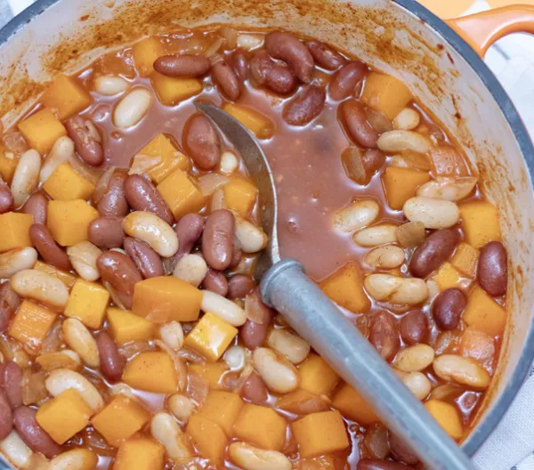 large pot of stew with a grey spoon in the pot