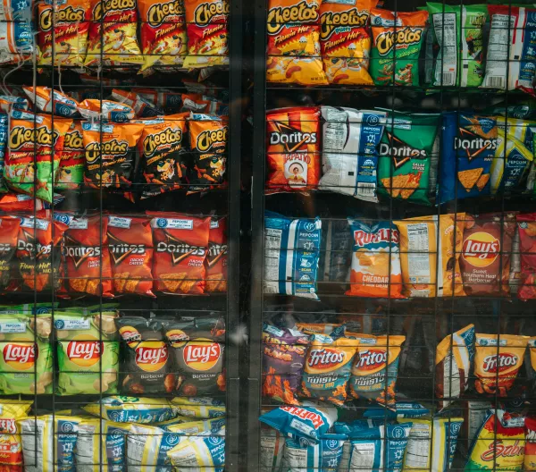 Shelves of assorted chips behind glass.