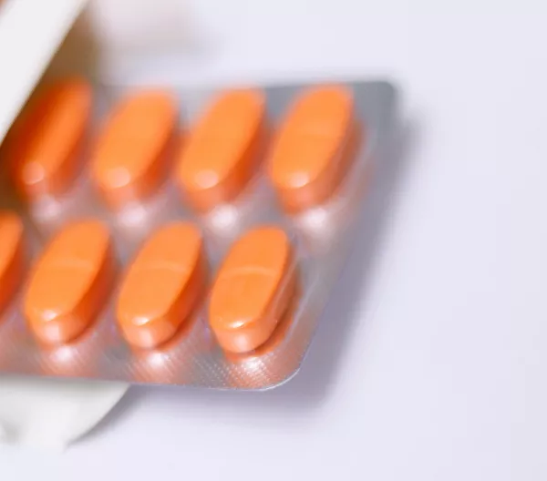 A blister pack of red oblong pills