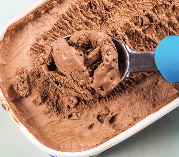 ice cream scoop in a 1.5 quart tub of chocolate ice cream