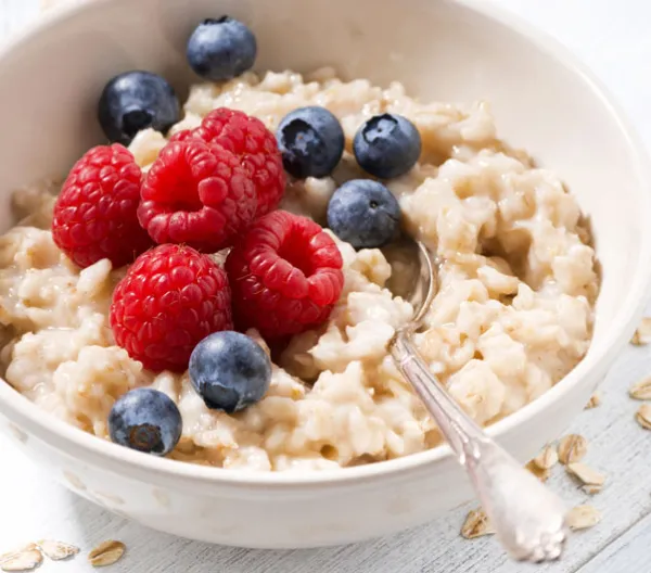 bowl of oatmeal with raspberries and blueberries
