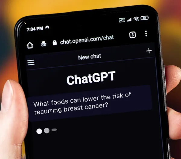 hand holding smart phone that says "ChatGPT" on screen