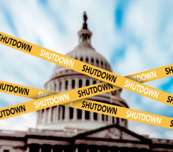 The U.S. Capitol dome behind caution tape with the word SHUTDOWN on it