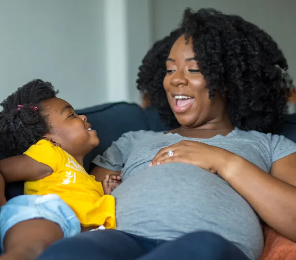 a pregnant mother and her daughter