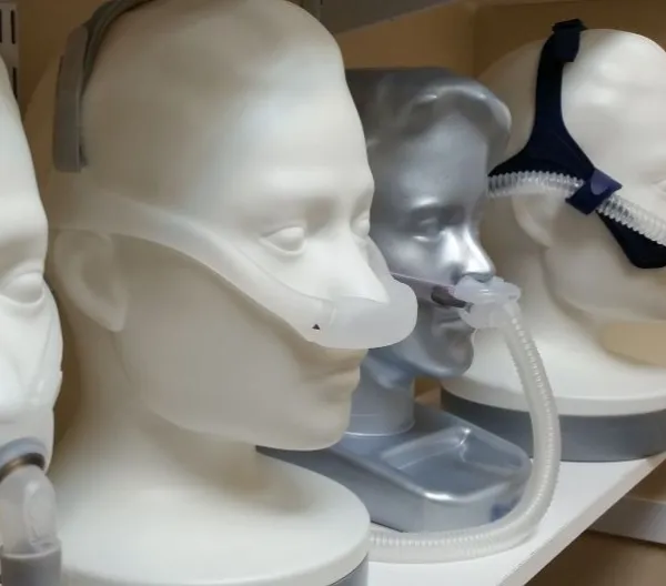 Model heads wearing various CPAP machines