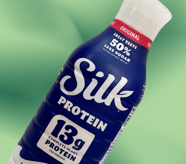 Silk protein milk on green background
