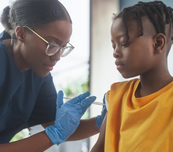 doctor giving child a vaccine in arm