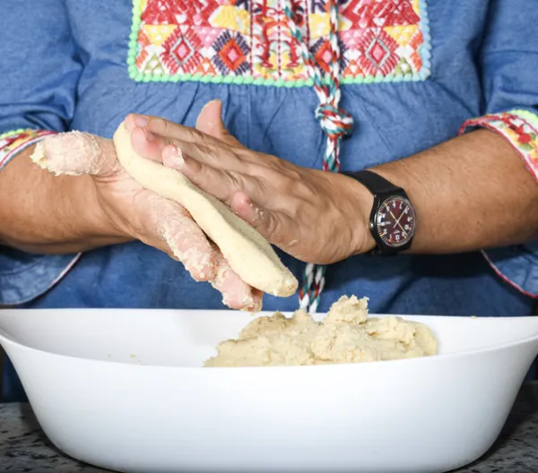 woman's hands making a corn flour tortilla