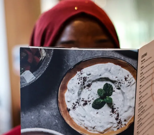A woman reading a menu.