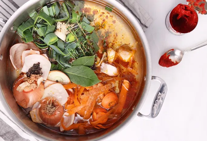 pot of water with vegetables inside