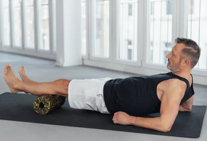 man using an exercise roller