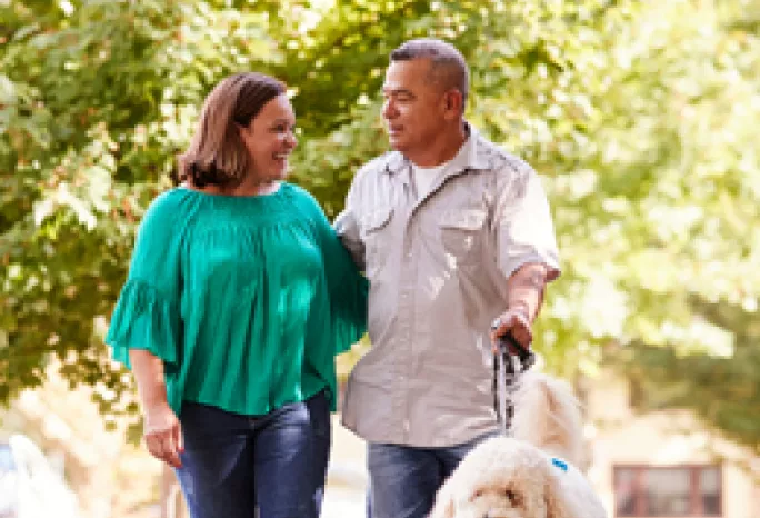 a couple walking their dog