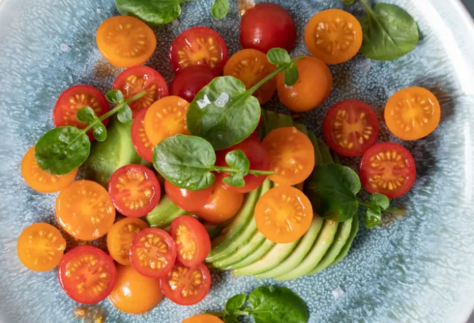 tomatoes and sliced avocado on plate