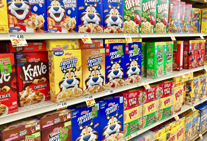 Grocery store shelves filled with sugary cereal