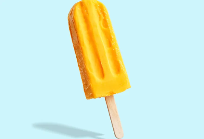 yellow popsicle on light blue background 