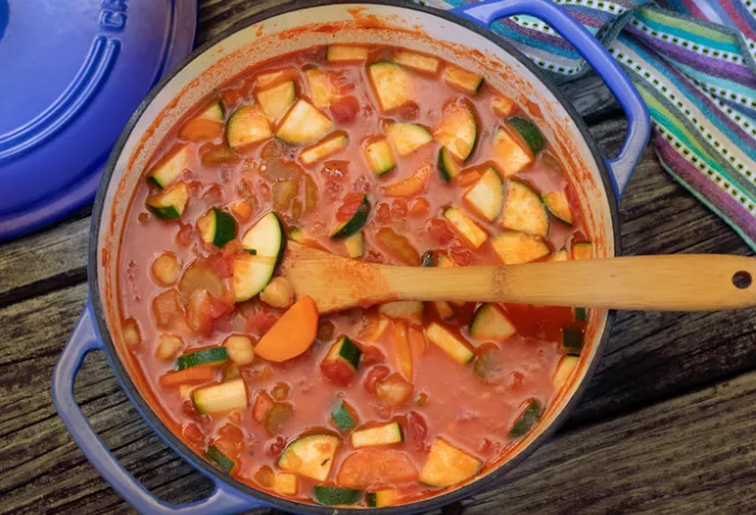 over head shot of large pot filled with minsestrone stew