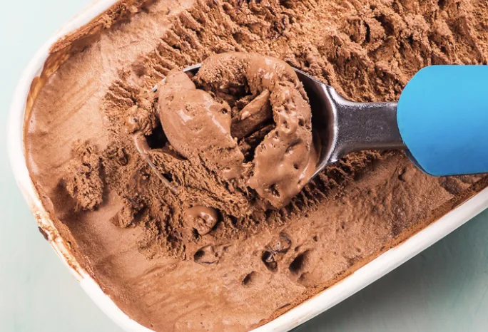 ice cream scoop in a 1.5 quart tub of chocolate ice cream