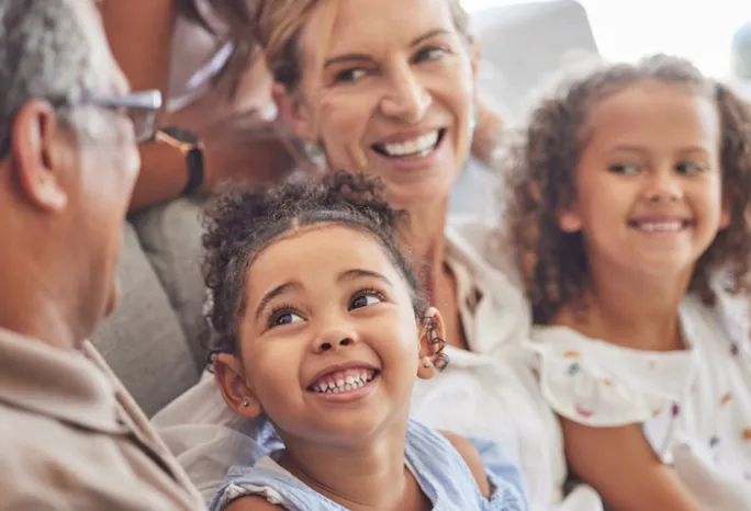 3 generations of women smiling at each other
