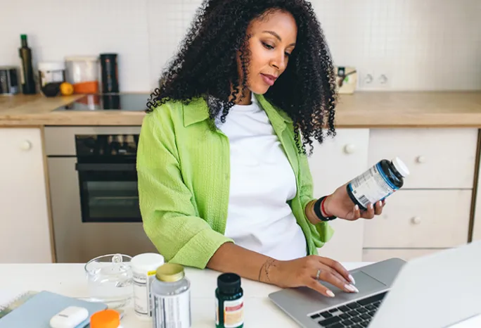 A woman researching supplements on her laptop