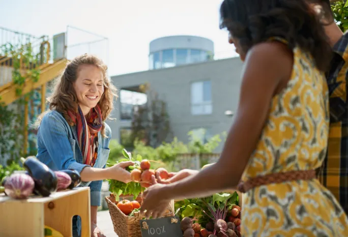 women buying and selling at a farmer's market