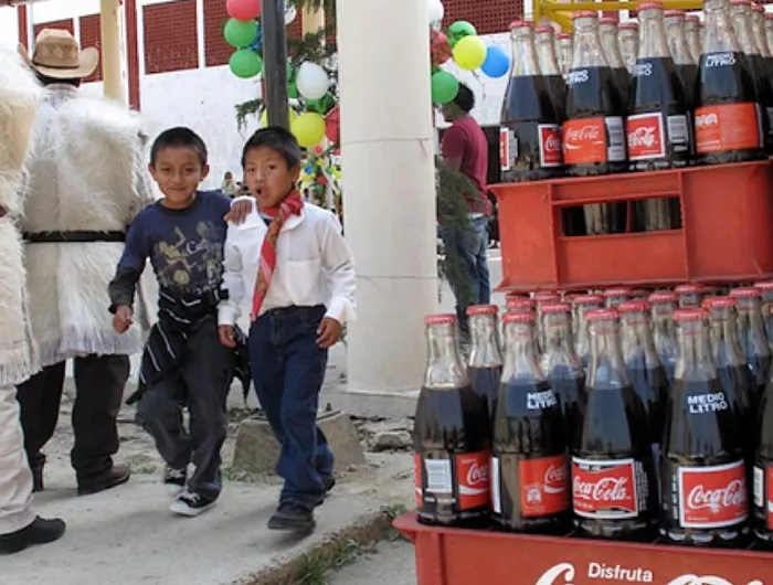 two boys walking past soda