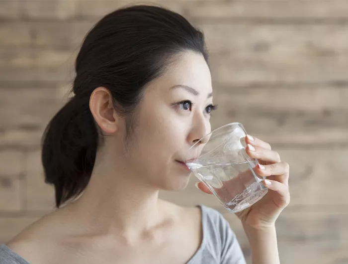woman drinking a glass of water