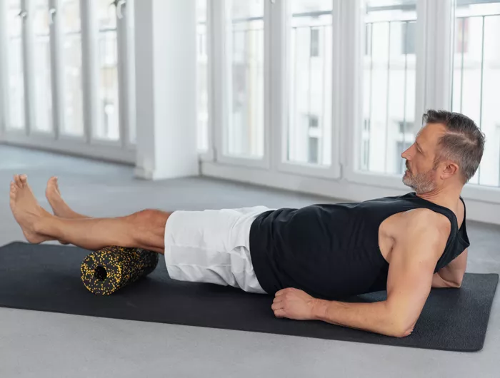 man using an exercise roller