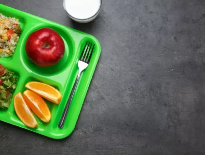 A lunch tray with fruit and vegetables