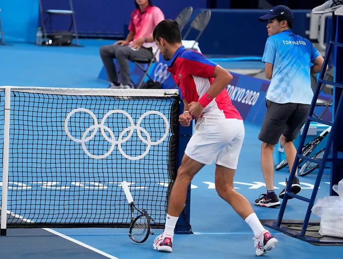 Tennis player Novak Djokovic from behind on the court