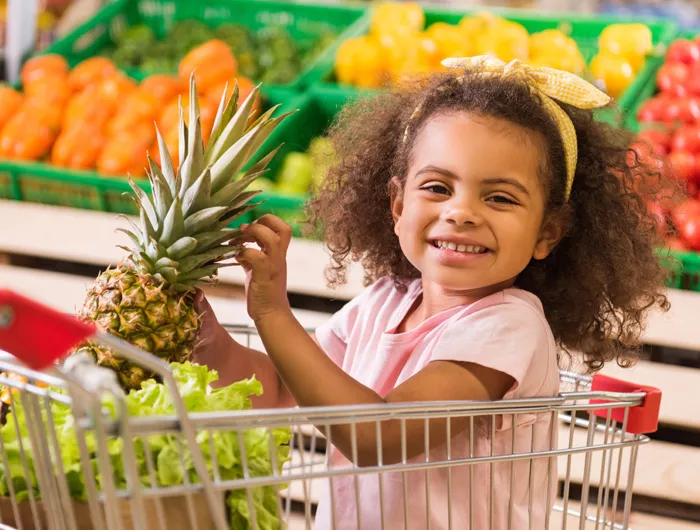 Small child holding produce