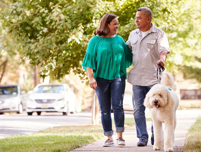 a couple walking their dog