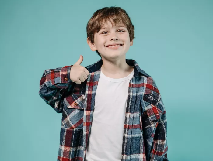 Kid giving a thumbs up